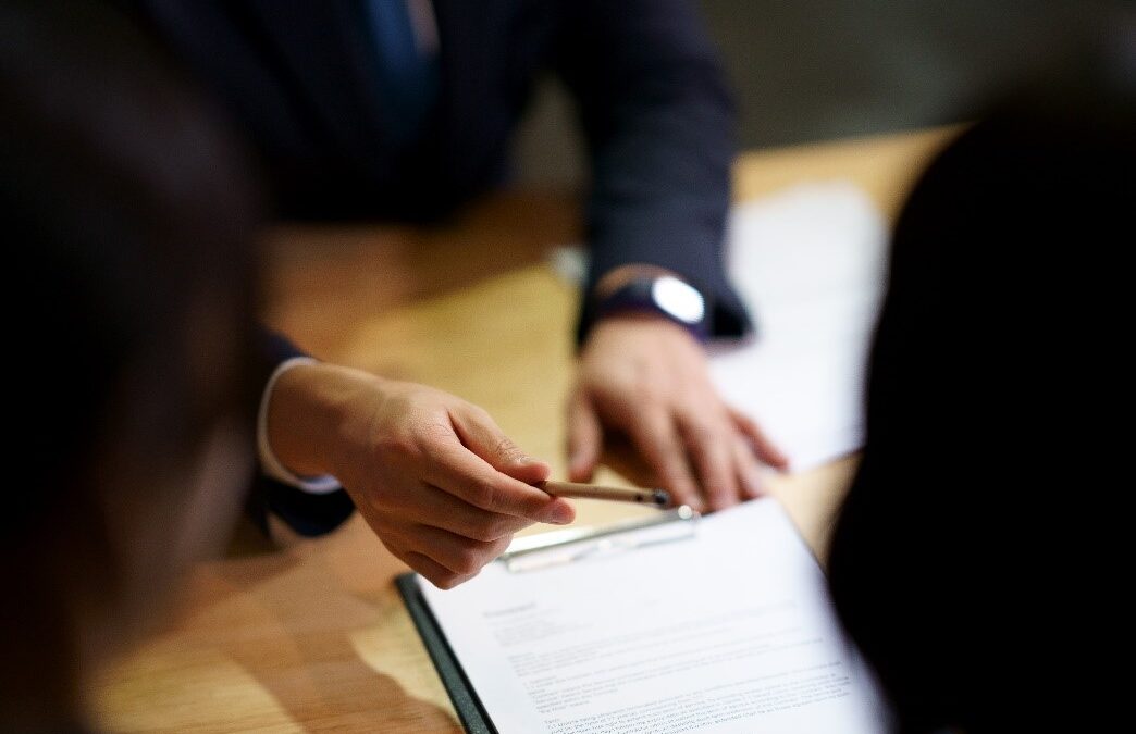 Man giving pen to sign the contract